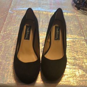 Black suede wedge pumps